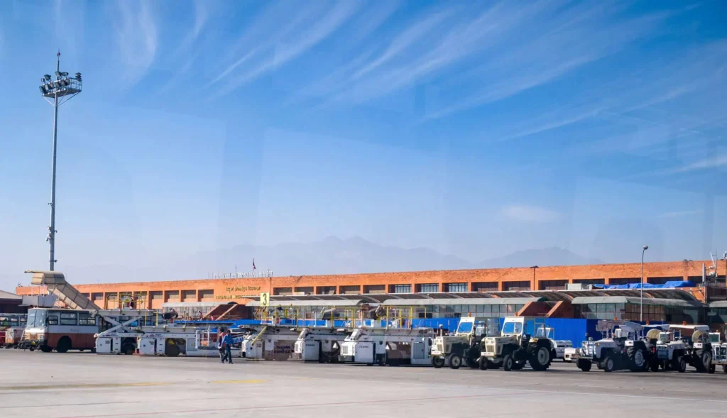 Busy airport with vehicles and terminal