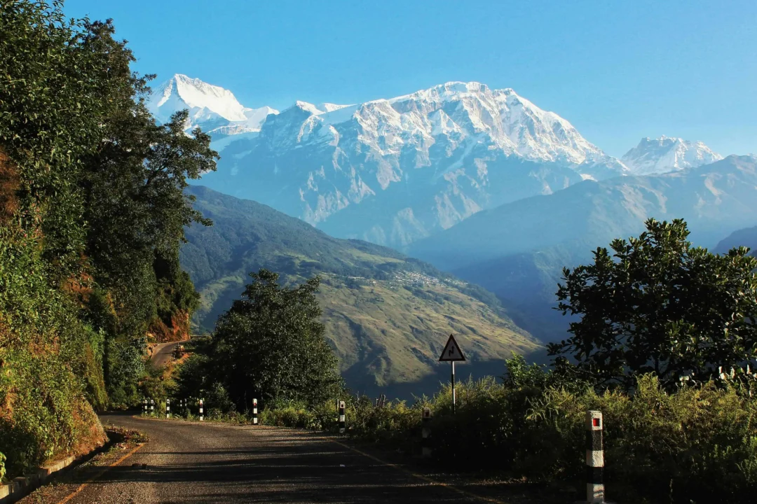 Mountain road with lush greenery backdrop one of the top road trips in Nepal