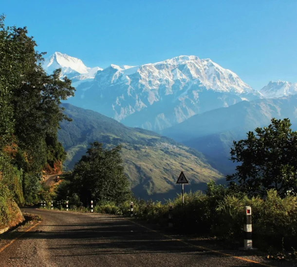 Mountain road with lush greenery backdrop one of the top road trips in Nepal