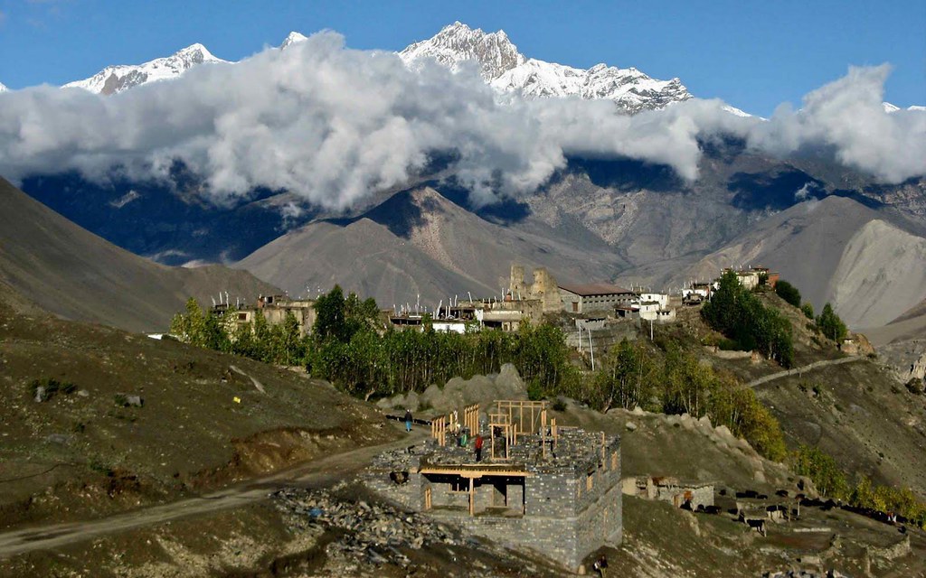 Himalayan hillside village with snow peaks