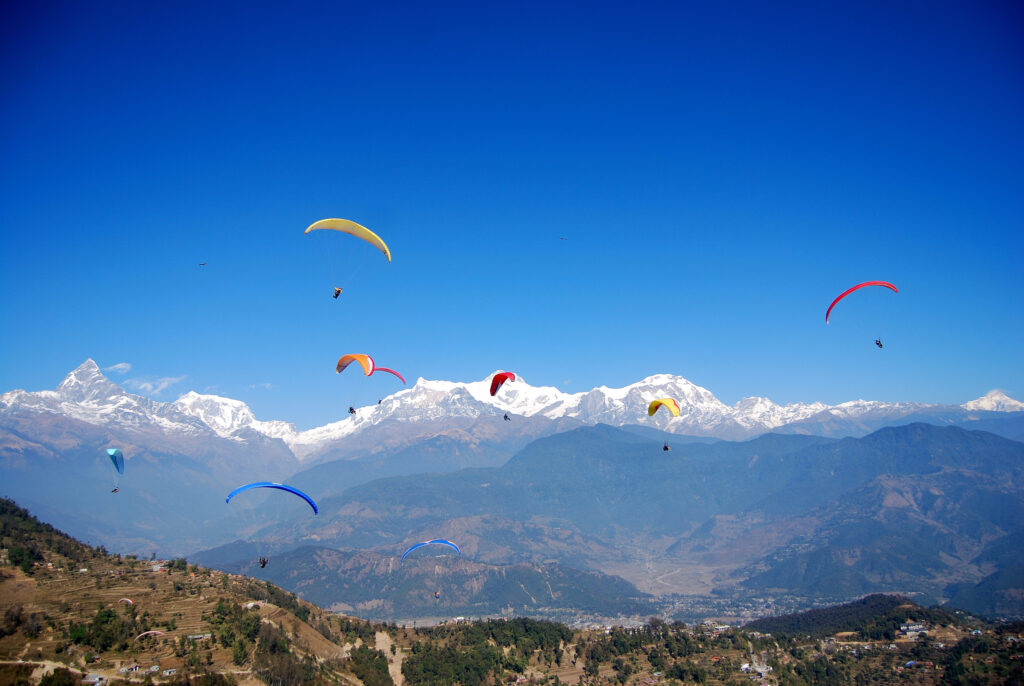 Women Travelers in Nepal paragliding over Himalayas