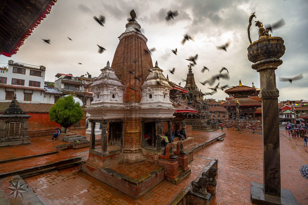 Women Travelers in Nepal exploring historic temple complex with pagoda roofs and cultural heritage